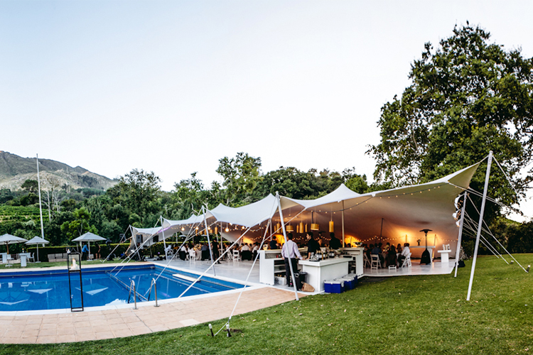 Nomadik Stretch Tent at an event next to a pool